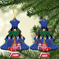 Blue bell-shaped ceramic Christmas ornament with gold hanger hanging on a tree
