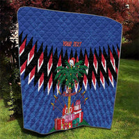 Blue quilt with quilted texture, zigzag stripes, palm tree, and wrapped gifts; custom text