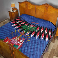 Blue quilt on bed with zigzag stripes, palm tree art, and Christmas presents; custom text