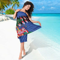 Blue Christmas sarong with zigzag trim and holiday presents graphic, draped over shoulder