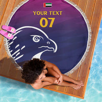 Round beach blanket with purple/navy falcon, white fringe edge, custom text 07 and UAE flag