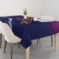 Custom tablecloth on a dining table with Arabian falcon graphic, dark blue and purple tones.