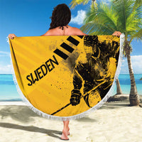 Yellow round beach blanket with fringe, hockey player and crown graphic held up by person