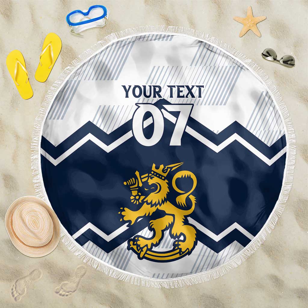 Round beach blanket with navy and yellow lion crest, chevron pattern, fringe edge