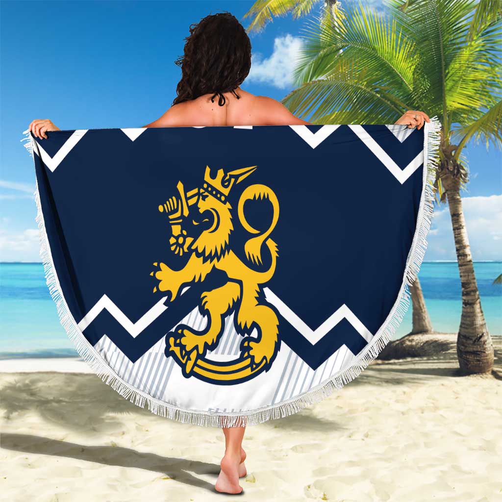 Round beach blanket held up on beach: navy chevrons and lion crest, fringe border