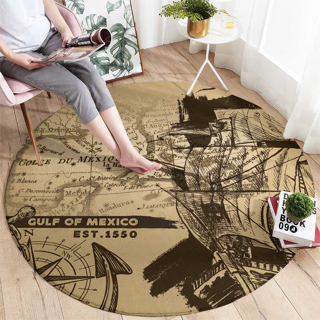 Round vintage map rug with tan background and black printed compass, waves, and sailboat