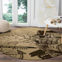 Round vintage map rug laid on wood floor, tan base with black harbor and coordinates print
