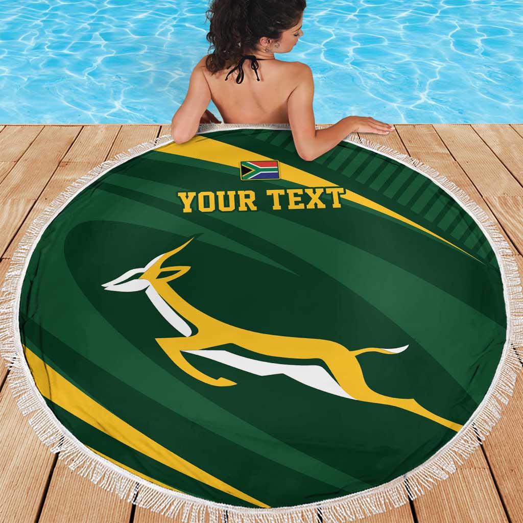 Round green personalized rugby beach blanket with fringe on wooden deck, “YOUR TEXT”