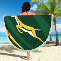 Round green personalized rugby beach blanket with fringe, South Africa emblem, on sand