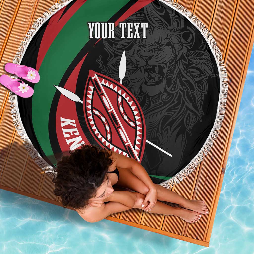 Round black beach blanket with Kenya shield emblem, “YOUR TEXT” lettering, and white fringe