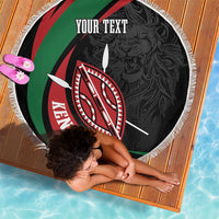 Round black beach blanket with Kenya shield emblem, “YOUR TEXT” lettering, and white fringe