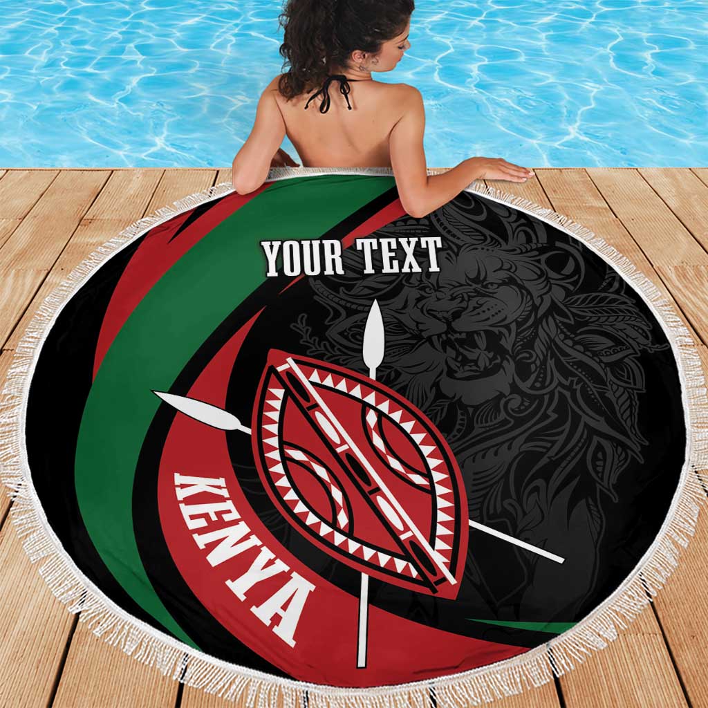 Round black beach blanket with green-red stripes, Kenya shield emblem, and white fringe