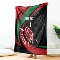Black throw blanket with red green diagonal design, shield emblem, and “YOUR TEXT”