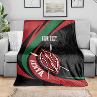Black blanket featuring lion warrior shield graphic and “YOUR TEXT” on a sofa