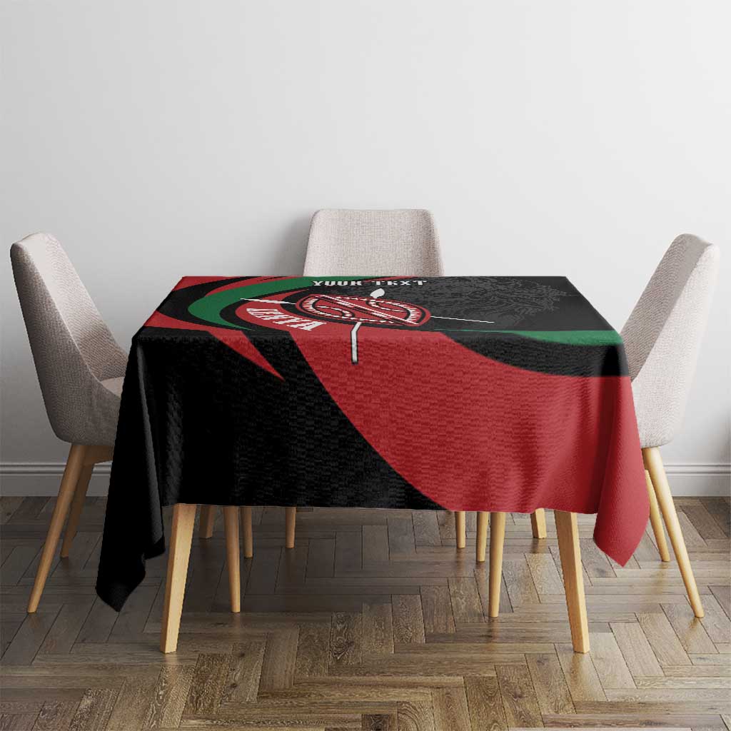 Personalized tablecloth on dining set, black with red and green emblem shield artwork