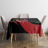 Personalized tablecloth on dining set, black with red and green emblem shield artwork