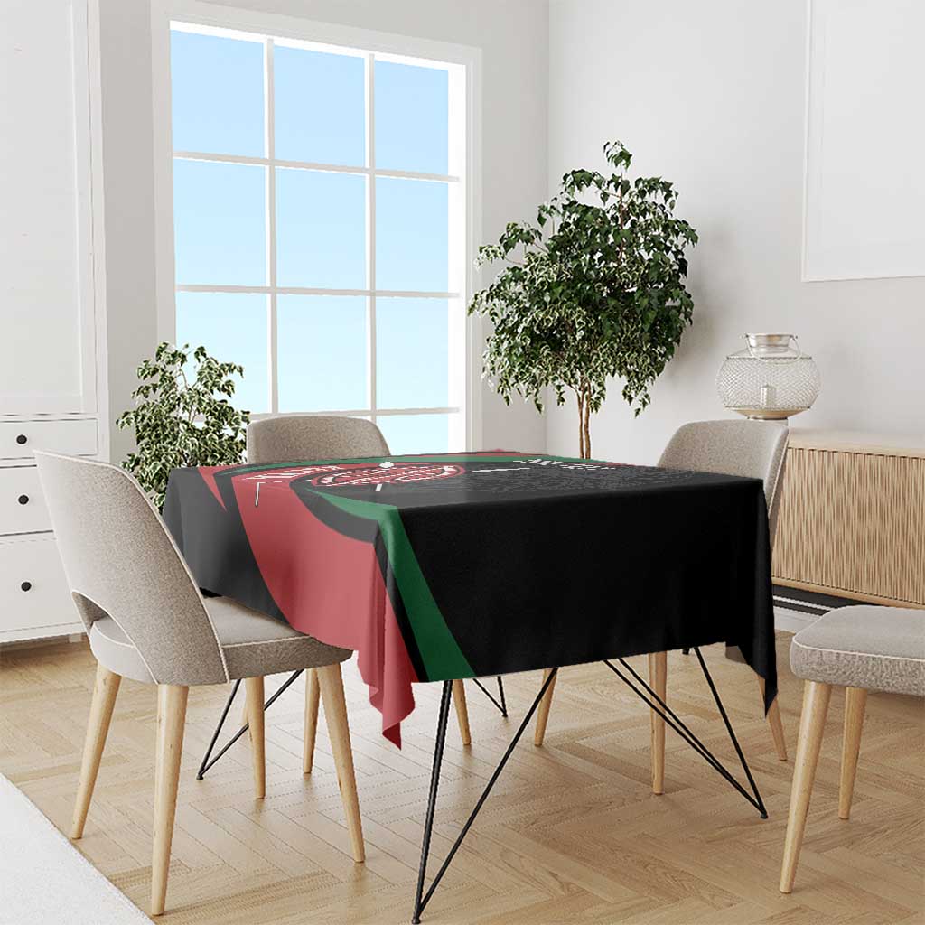 Personalized tablecloth on dining table, black with red and green warrior shield print