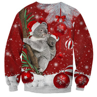 Red Christmas sweatshirt with koala graphic, hanging ornaments, holly leaves, and sparkles