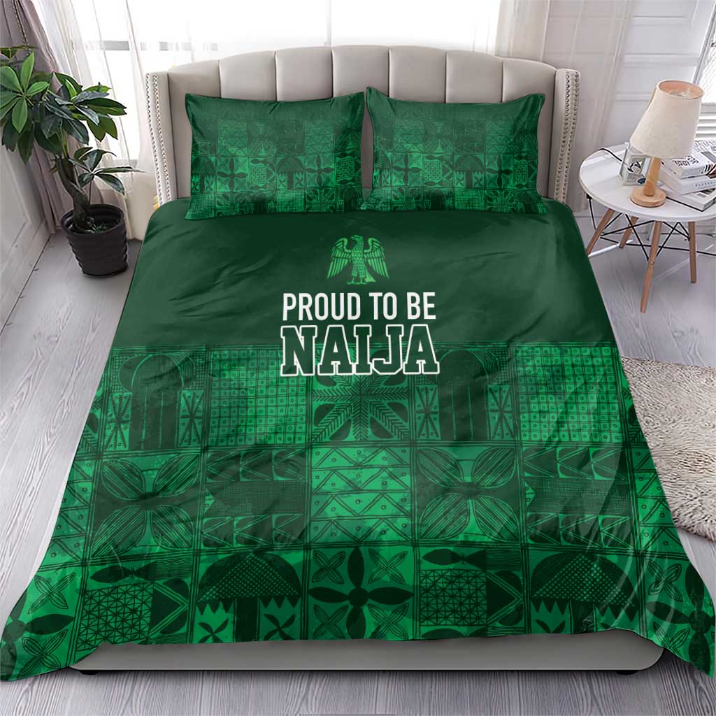 Dark green duvet and matching pillows with adire-inspired geometric pattern and “PROUD TO BE NAJA” print