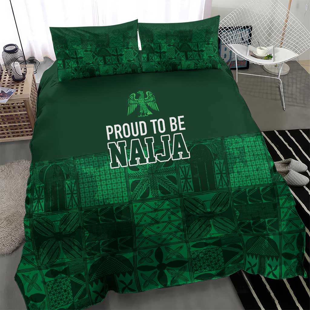 Dark green bedding set with geometric adire-style patchwork, “PROUD TO BE NAJA” centered on duvet