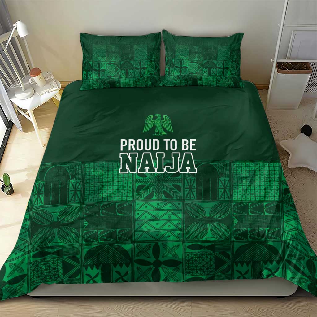 Dark green duvet and pillow set with adire geometric patterning and “PROUD TO BE NAJA” lettering