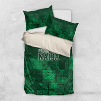 Dark green bedding set with adire-style geometric blocks and “PROUD TO BE NAJA” print, two pillows