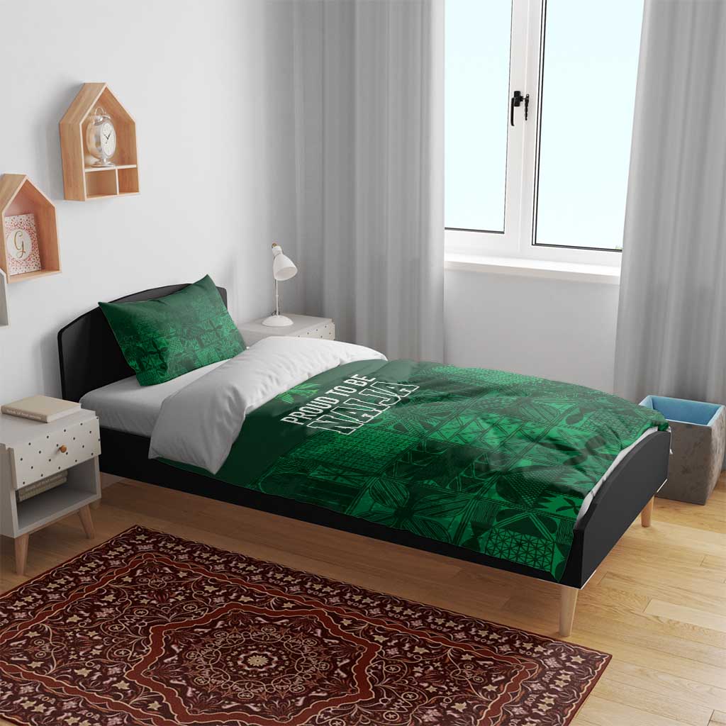 Dark green duvet with adire-inspired geometric design and “PROUD TO BE NAJA” text on bed