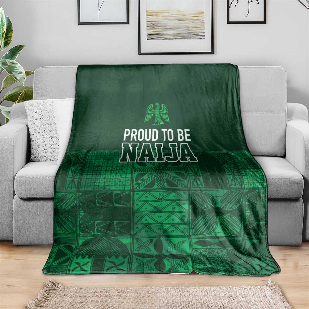 Dark green adire-pattern blanket featuring 'Proud to be Naija' text and patterned panels