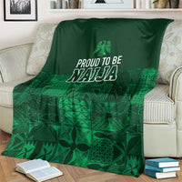 Dark green adire-pattern blanket with centered 'Proud to be Naija' print and leaf motifs