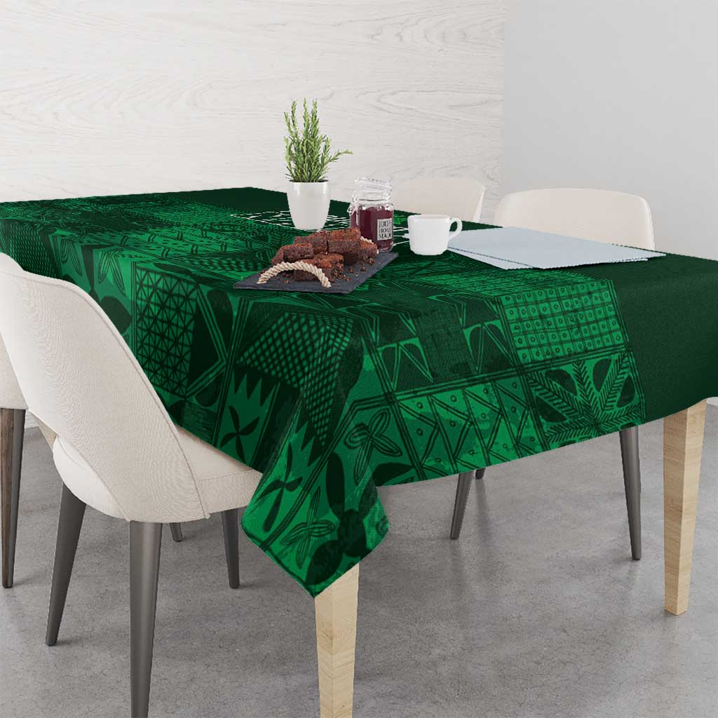 Dark green tablecloth with geometric adire motifs, spread across dining table