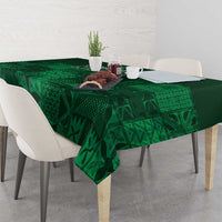 Dark green tablecloth with geometric adire motifs, spread across dining table