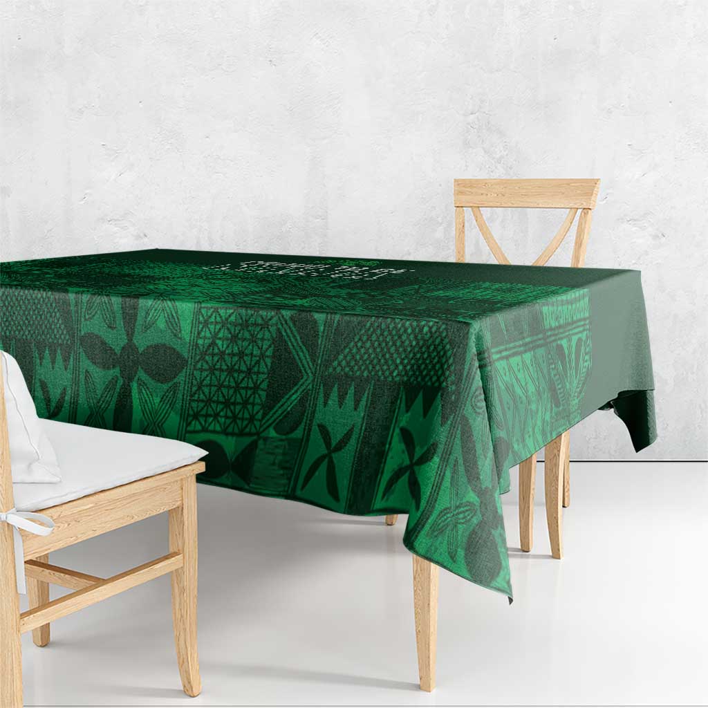 Dark green tablecloth with geometric adire motifs, hanging over table edge
