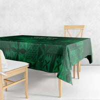 Dark green tablecloth with geometric adire motifs, hanging over table edge