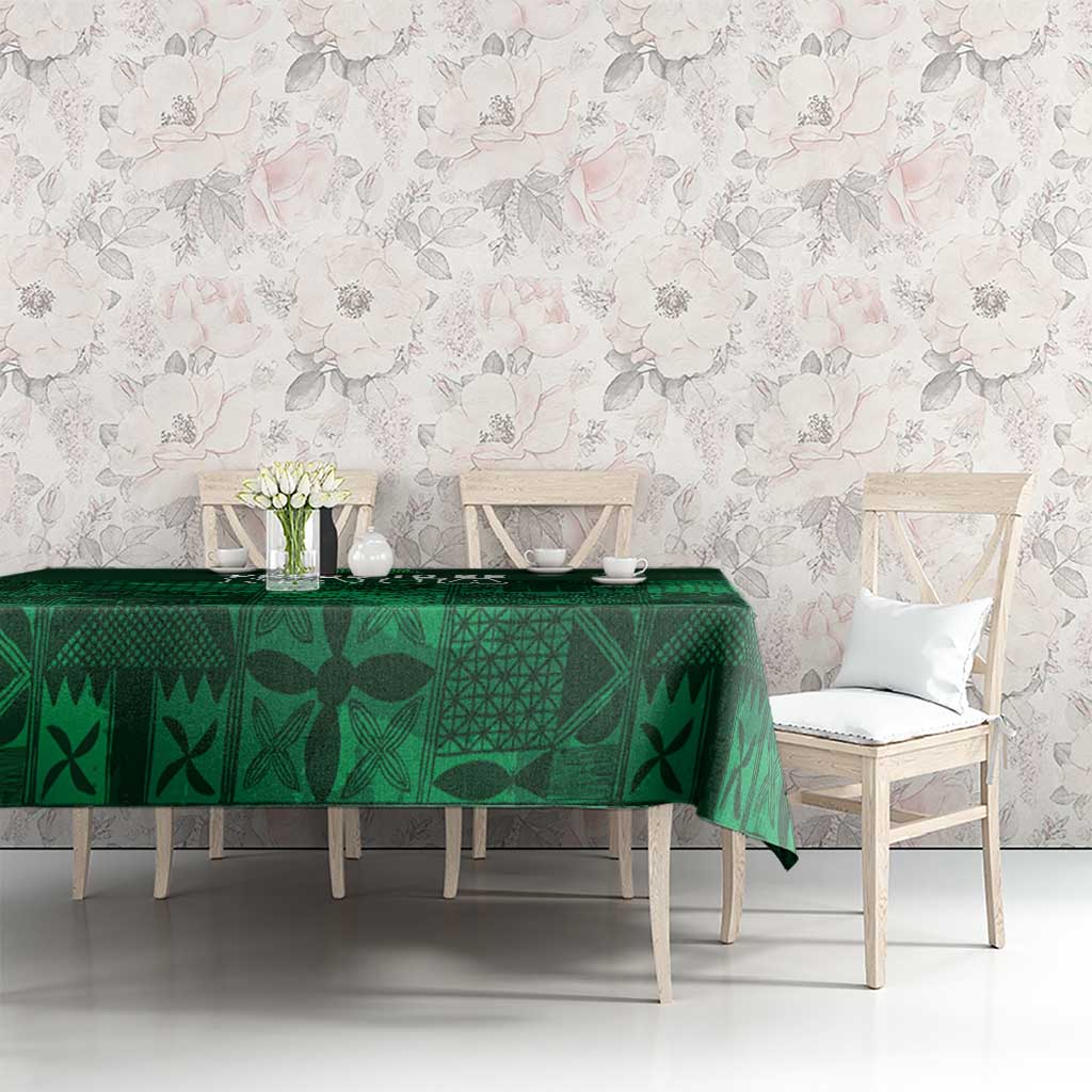 Dark green tablecloth with Yoruba-inspired adire geometric motifs, on dining table