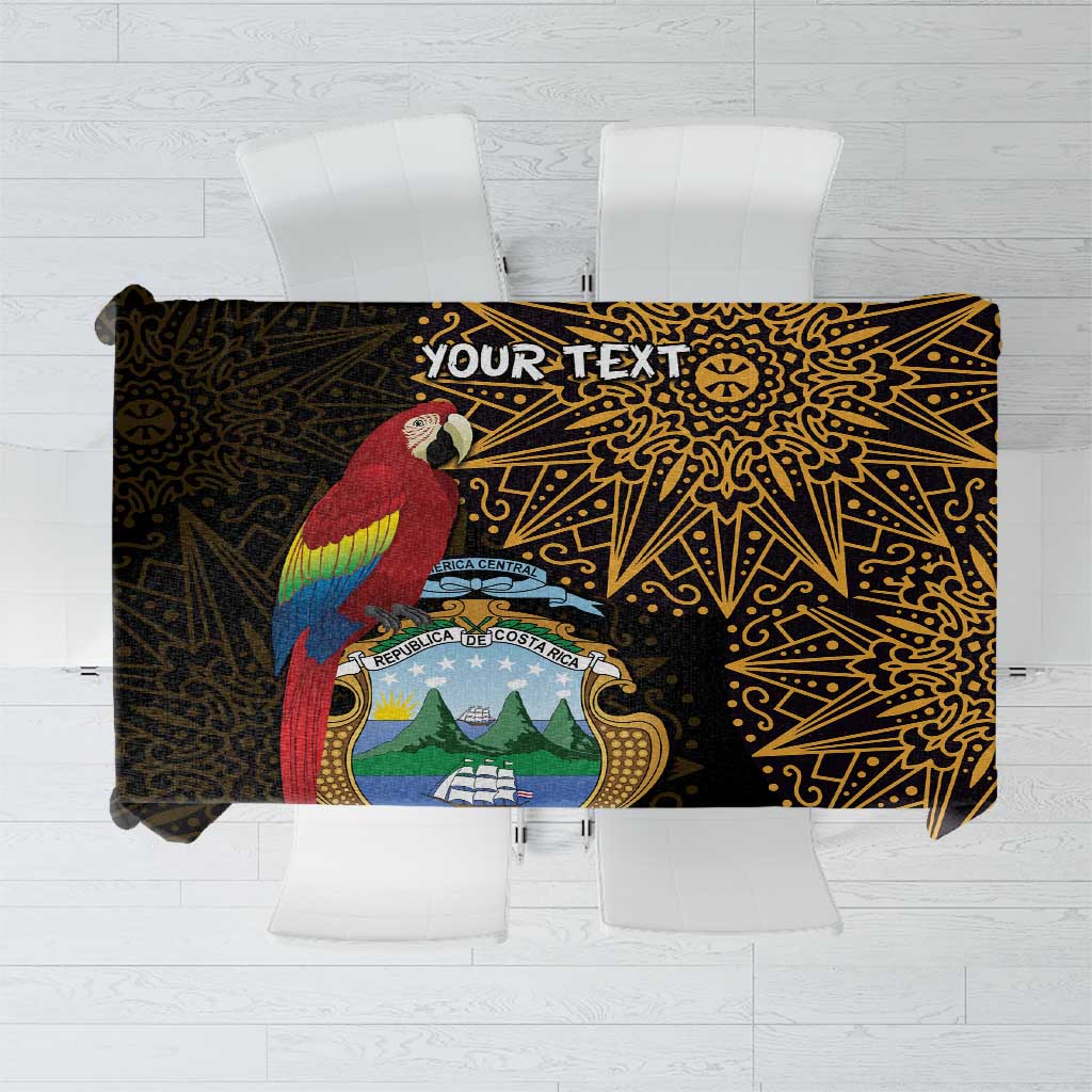 Black tablecloth with gold ornate pattern and personalized text banner centerpiece.