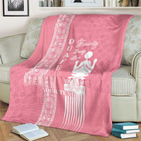 Pink blanket with white woman symbol, Adinkra-like patterns, and “YOUR TEXT” text