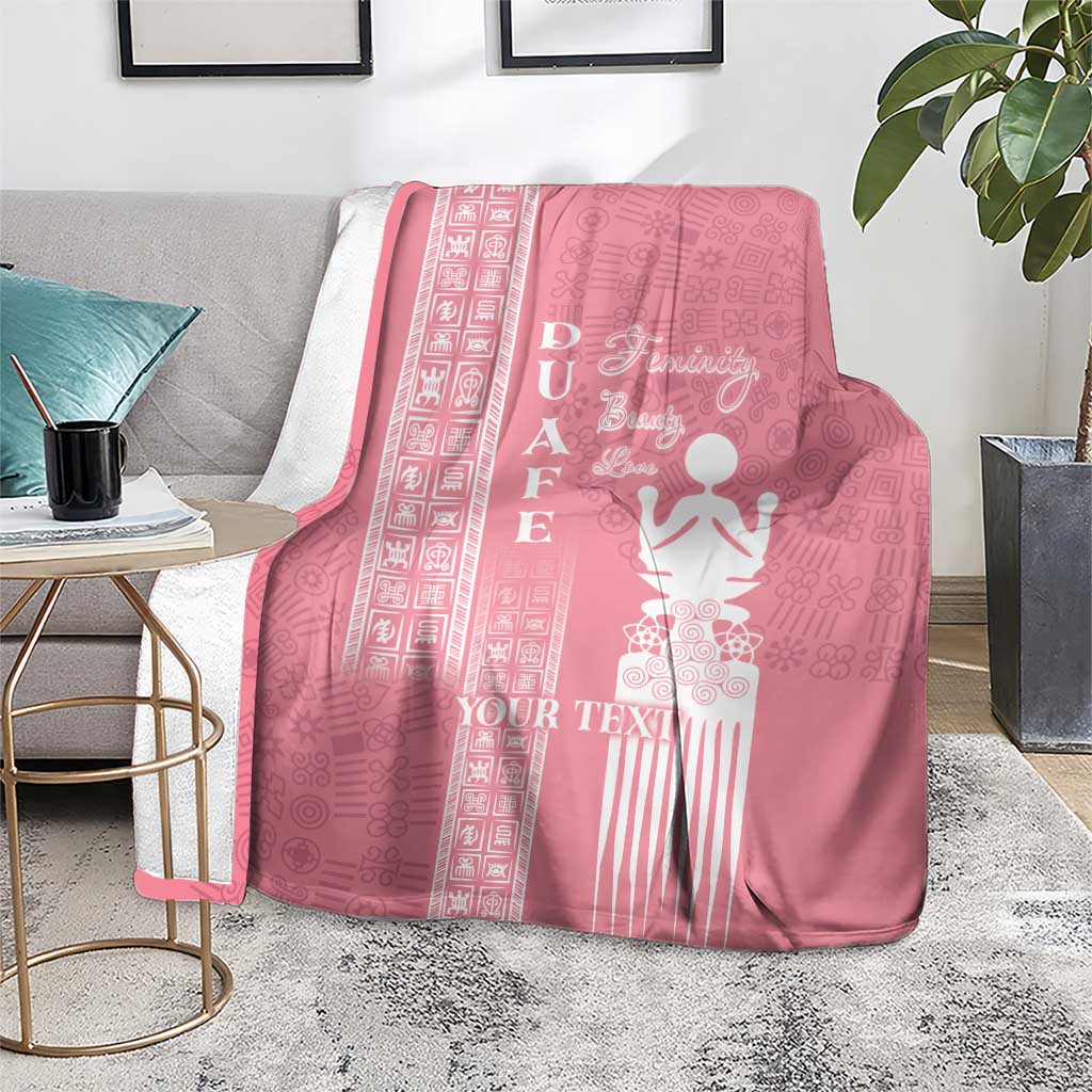 Pink blanket on a rug with white “YOUR TEXT” and woman figure motif in center
