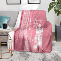 Pink blanket on a rug with white “YOUR TEXT” and woman figure motif in center