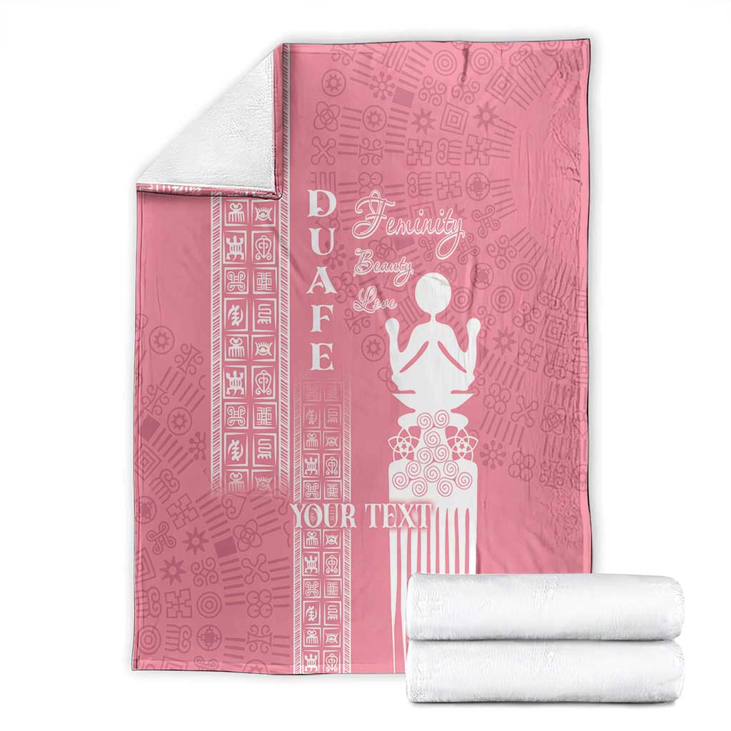 Pink blanket folded with white “YOUR TEXT” and woman motif, plus patterned side stripes