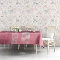 Pink tablecloth with ornate border and repeating geometric motifs
