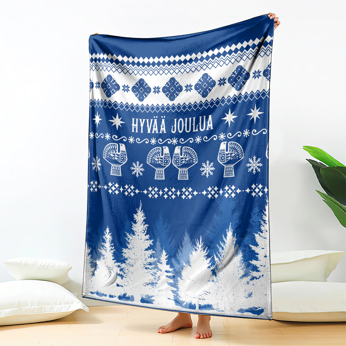 Christmas throw blanket in blue with Finnish-style motifs and Hyvaa Joulua text