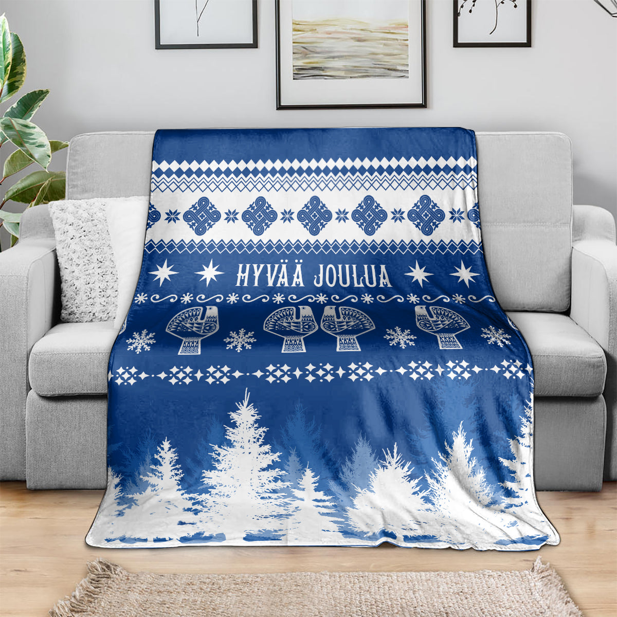 Blue Christmas blanket with Finnish festive pattern, text, and tree border