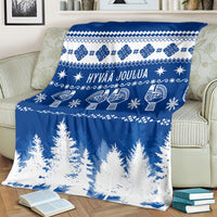 Blue Christmas throw blanket with Finnish pattern, text, and pine tree design