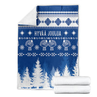 Blue Christmas blanket with white Hannunvaakuna pattern and Hyvaa Joulua text