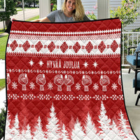 Red and white Christmas quilt with 'HYVAA JOULUA' text, reindeer and fir trees
