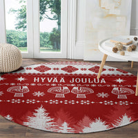 Round red Christmas rug with white Hannunvaakuna motifs and Hyvaa Joulua text
