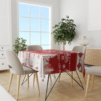 Red and white Christmas tablecloth on dining table with snowflake and icon details