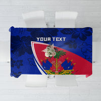 Haiti flag-themed tablecloth in blue, red, and green with hibiscus pattern.