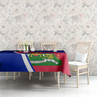 Blue hibiscus tablecloth with Haiti flag design draped on dining bench.