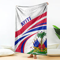Haiti flag style printed blanket with blue, red, and green emblems on light gray.
